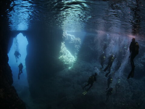 scuba divers are exploring the caves underwater