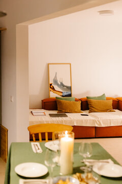 A house showing a cozy living room and a table set for dinner