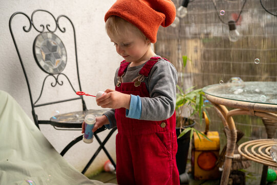 Little girl playing with bubbles 