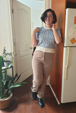 Candid photo of a woman with a vintage, colorful outfit in a kitchen.