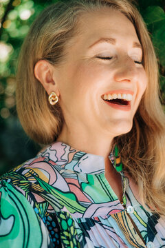 Laughing female close-up portrait in natural outdoor light