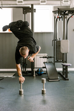 A man is working out in the gym.