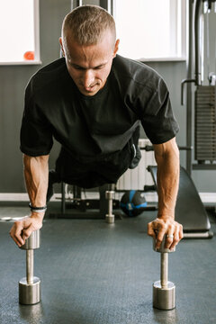 A man is working out in the gym.