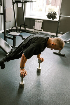 A man is working out in the gym.