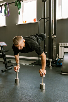 A man is working out in the gym.
