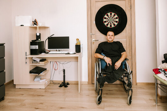 A man is sitting in his room.
