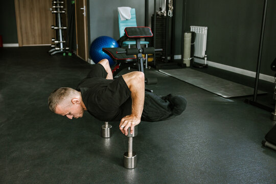 A man is working out in the gym.
