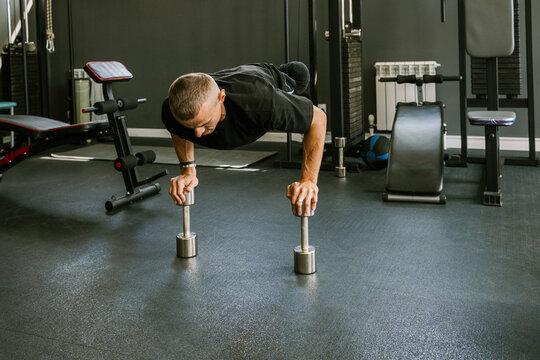 A man is working out in the gym.