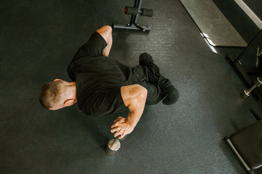 A man is working out in the gym.