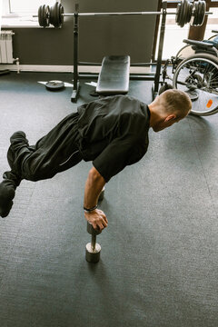 A man is working out in the gym.