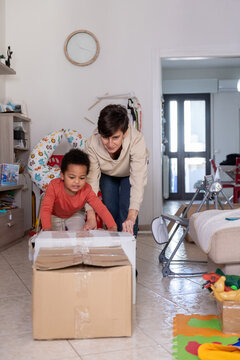 Mom and Son Moving Boxes in a Living Room