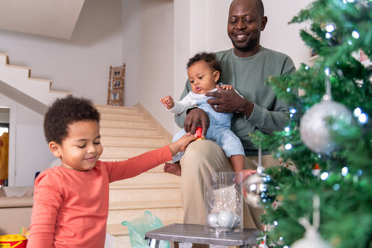 Father and sons preparing for Christmas together at hom