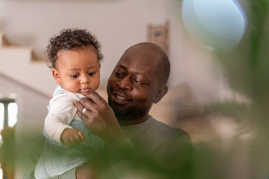 Father wipes the baby's mouth at home