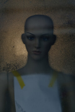 abstract mannequin behind fogged glass