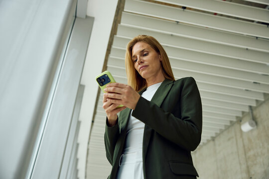 Businesswoman sending text messages