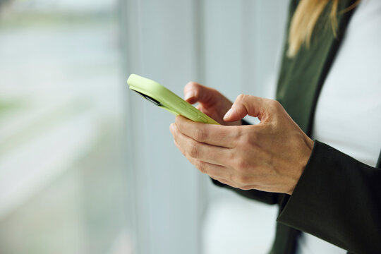 Anonymous woman texts on her phone