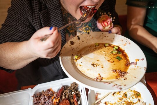 Woman Eating Takeout Meal Indoors