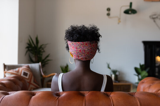 Woman sitting on sofa at home