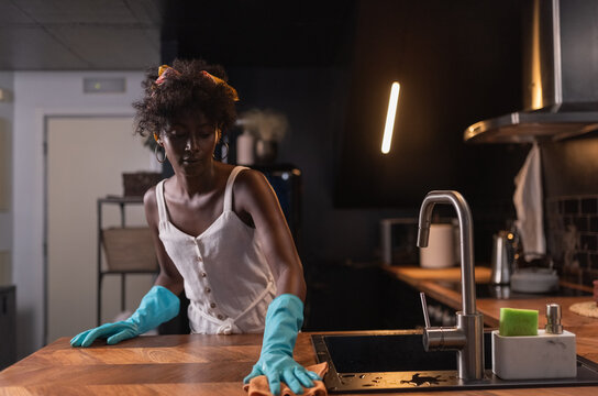 Woman wiping kitchen counter 