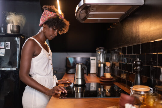 Woman Prepares Coffee in Modern Kitchen During Morning Routine