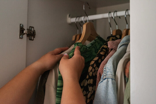 Organizing Clothes in a Closet During the Afternoon