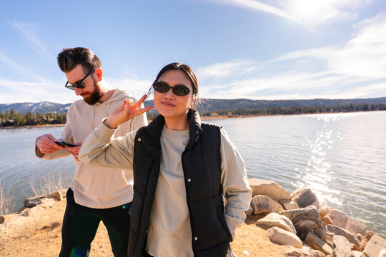 friends hanging out by lake