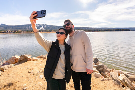 Couple Takes a Selfie by the Lake During the Day