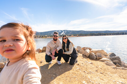 Family Enjoys Time by the Lake With Child Taking a Selfie