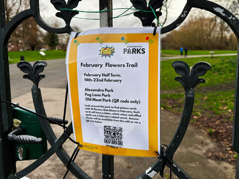 February Flowers Trail poster on gate at Alexandra Park, Manchester, UK promoting free family event