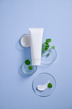 A minimalist beauty product display featuring a white tube