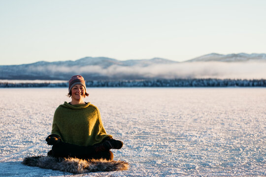 Woman meditating outdoors in winter light