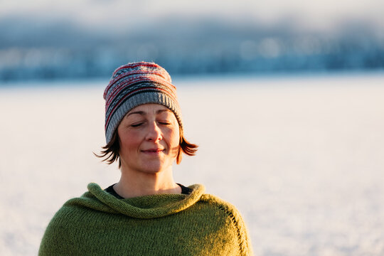 Close-up of woman meditating in winter light