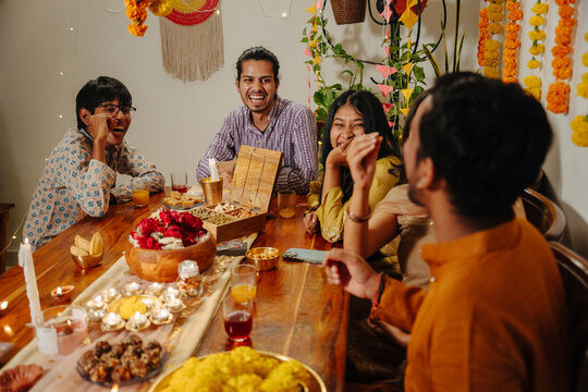 Friends Gather Around a Table for Diwali Celebration 