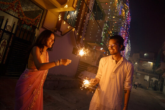 Diwali celebration With Sparklers at Night in a decorated street