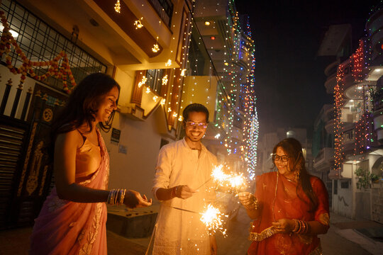 Diwali Celebration With Sparklers in Festive Street at Night