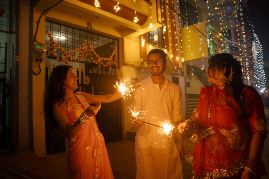 Diwali Celebration With Friends in a Decorated Street at Night