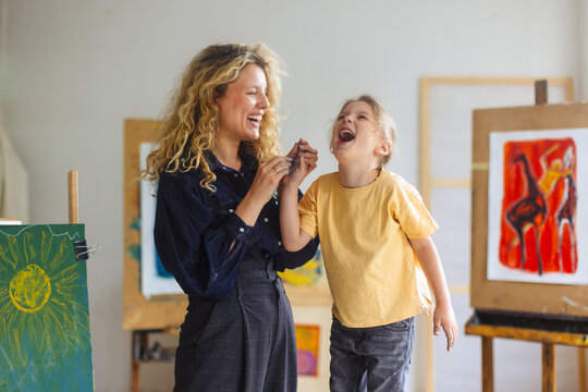 Joyful Mother And Child Laughing During Art Class