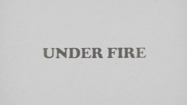 CMYK Halftone Text Under Fire Printed on Changing Paper with Vintage Stop Motion Effect.