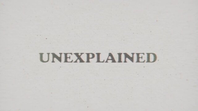 CMYK Halftone Text Unexplained Printed on Changing Paper with Vintage Stop Motion Effect.
