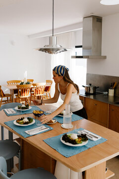Woman setting the table for a salad dinner