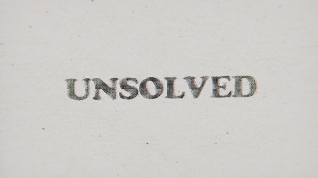 CMYK Halftone Text Unsolved Printed on Changing Paper with Vintage Stop Motion Effect.