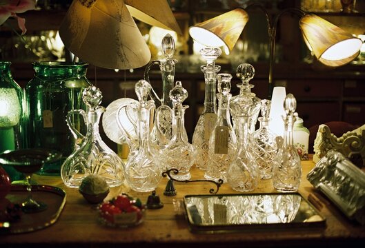 Antique Crystal Decanters in Warm Shop Light
