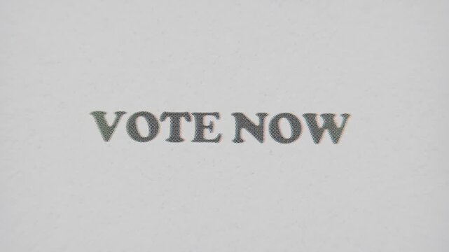 CMYK Halftone Text Vote Now Printed on Changing Paper with Vintage Stop Motion Effect.