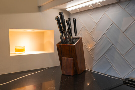 Knife set in wood block on black kitchen counter