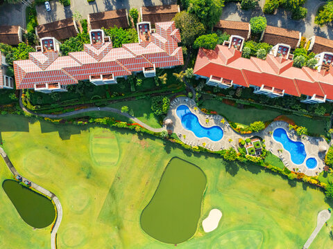 Aerial view of hotel with pool, lakes and vast natural fields