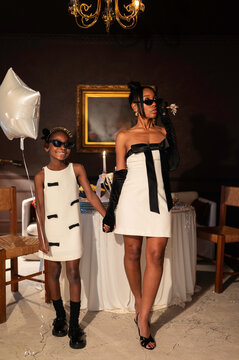 Mother and Daughter Celebrate in Matching Outfits at a Party