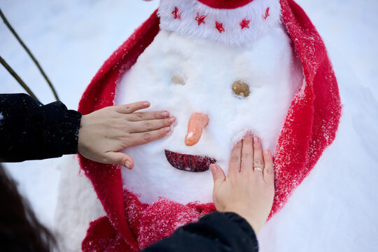 Woman Shaping a Snowman Face