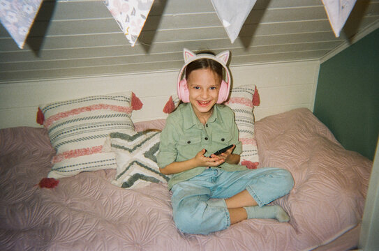 Happy Moment of Playing Mobile Game on Bed at Home
