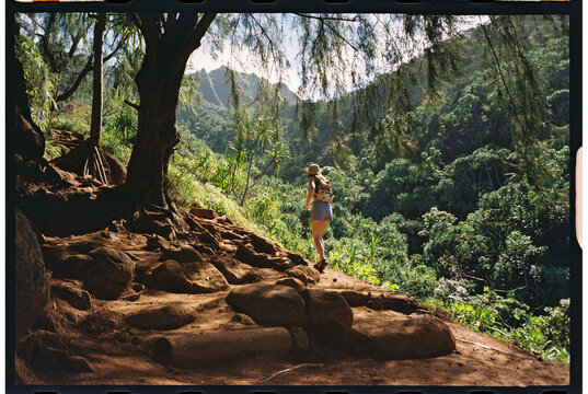 hiker exploring mountainside trail kauai 