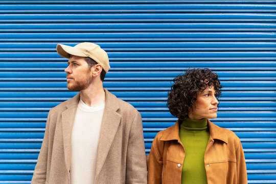 Man and woman looking away